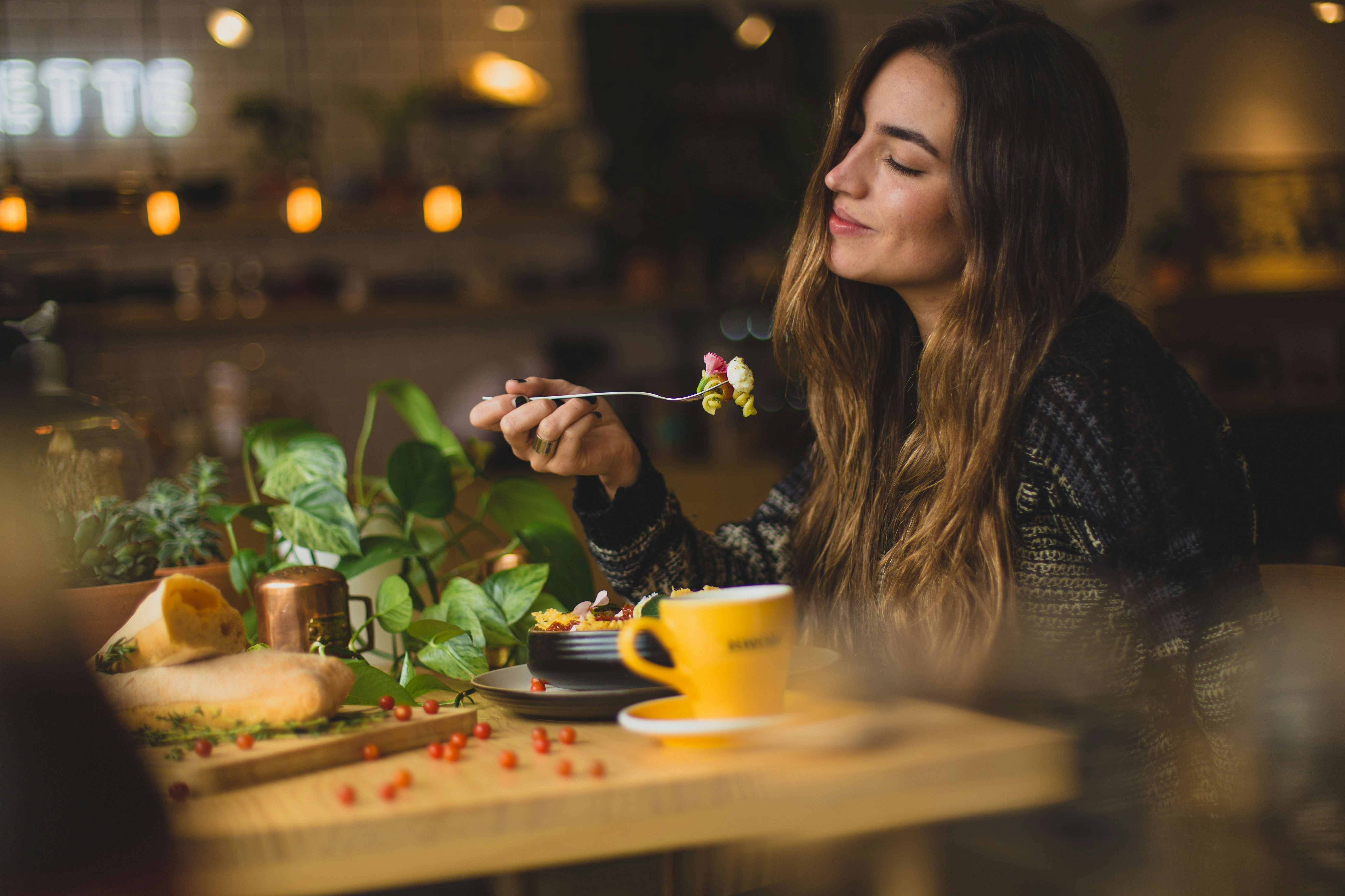 An image of a woman enjoying her food.